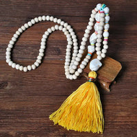 PORTS:  BOHEMIAN TASSEL NECK